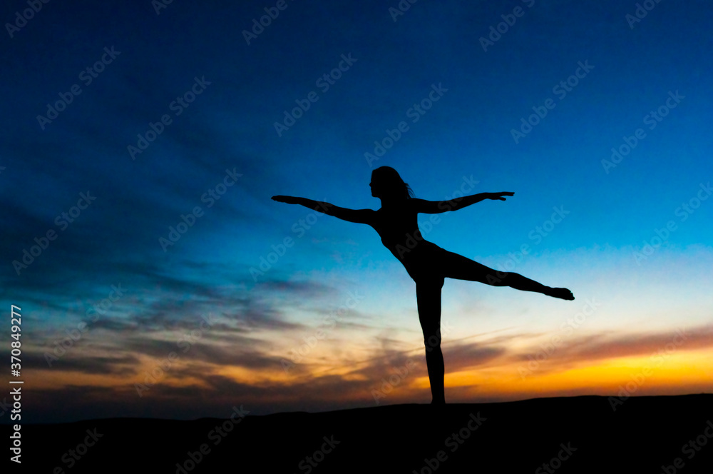 Silhouette of woman dancing at sunset, Gran Canaria, Spain Silhouette of woman dancing at sunset, Gran Canaria, Spain