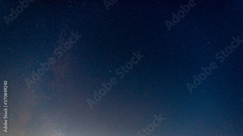 The starry night sky. The Milky Way and the bright meteorite. A starry landscape.