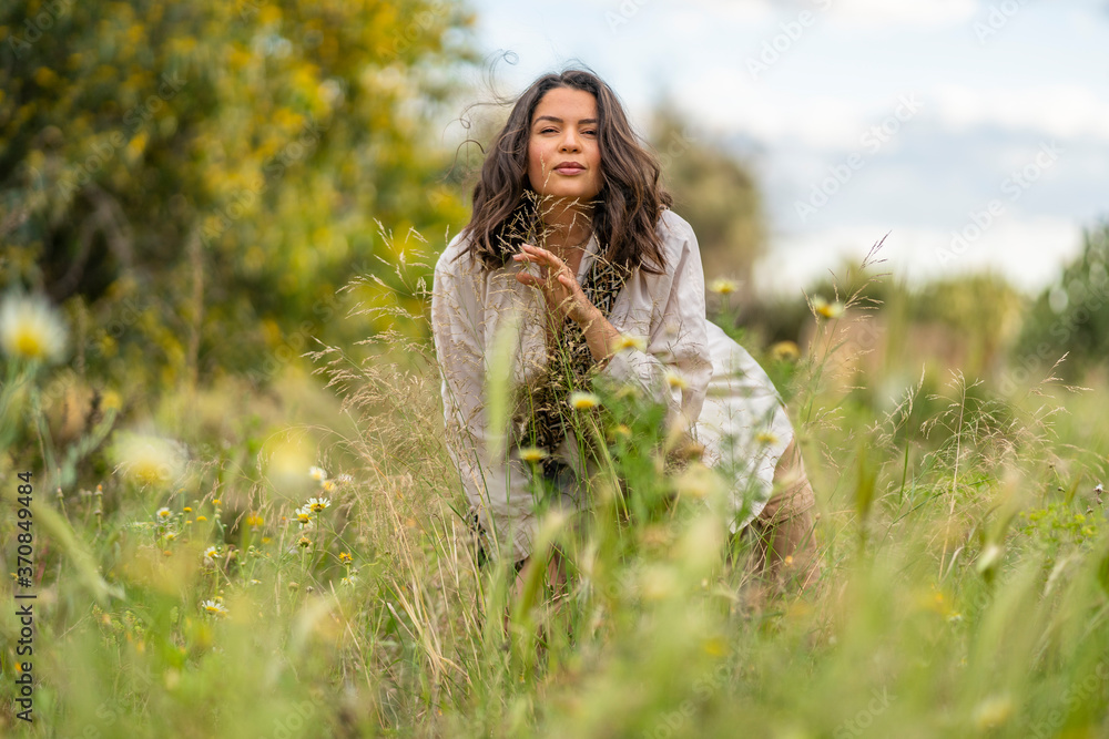 Portrait of beautiful woman standing on green plants against sky, Alicante, Alicante Province, Spain Portrait of beautiful woman standing on green plants against sky, Alicante, Alicante Province, Spain