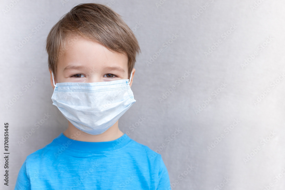 Portrait of Toddler kid wearing medical mask.A boy wearing mouth mask against air smog pollution. Concept of coronavirus quarantine or covid-19.Protection against virus and infection control concept Portrait of Toddler kid wearing medical mask.A boy wearing mouth mask against air smog pollution. Concept of coronavirus quarantine or covid-19.Protection against virus and infection control concept