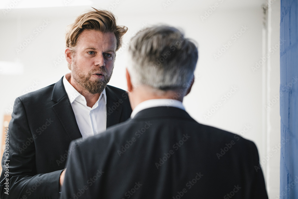Two businessmen disussing in office Two businessmen disussing in office