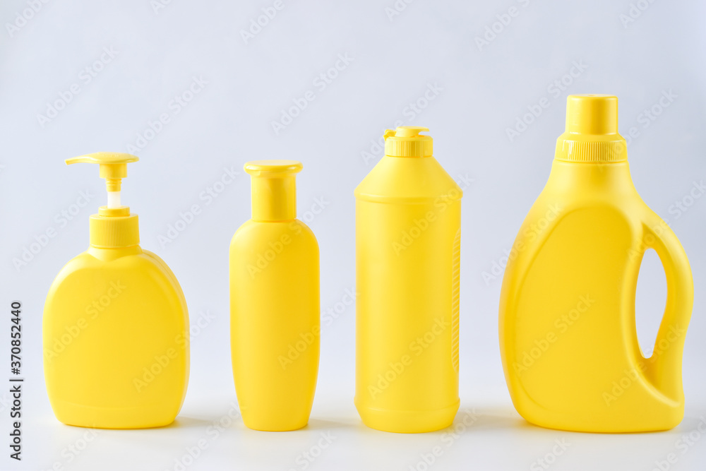 Four yellow plastic bottles on a white background Four yellow plastic bottles on a white background