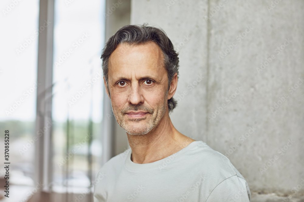 Portrait of a confident senior man in a loft flat Portrait of a confident senior man in a loft flat