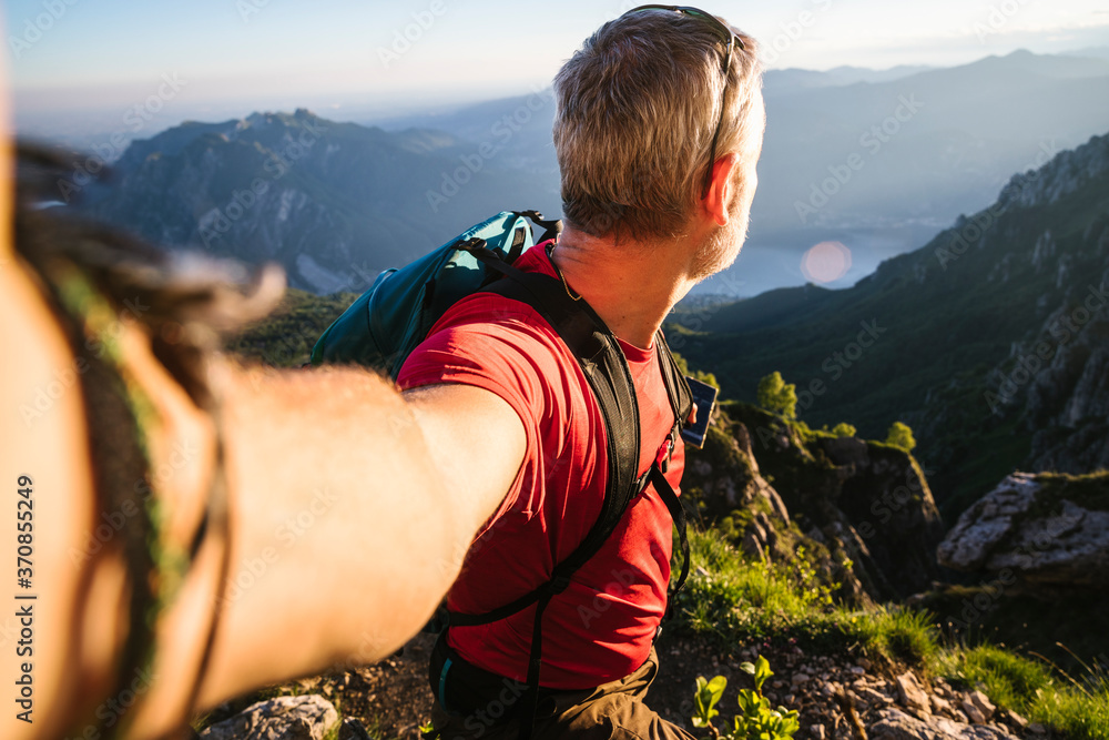 Mature man looking at view while standing on mountain during sunset, Orobie, Lecco, Italy Mature man looking at view while standing on mountain during sunset, Orobie, Lecco, Italy