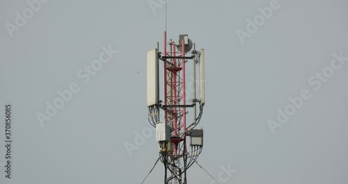 Close-up shot of Telecommunication tower. Telecom tower antennas and satellite transmits the signals of cellular 5g 4g mobile signals to the consumers and smartphones. 4k. 23.98 fps