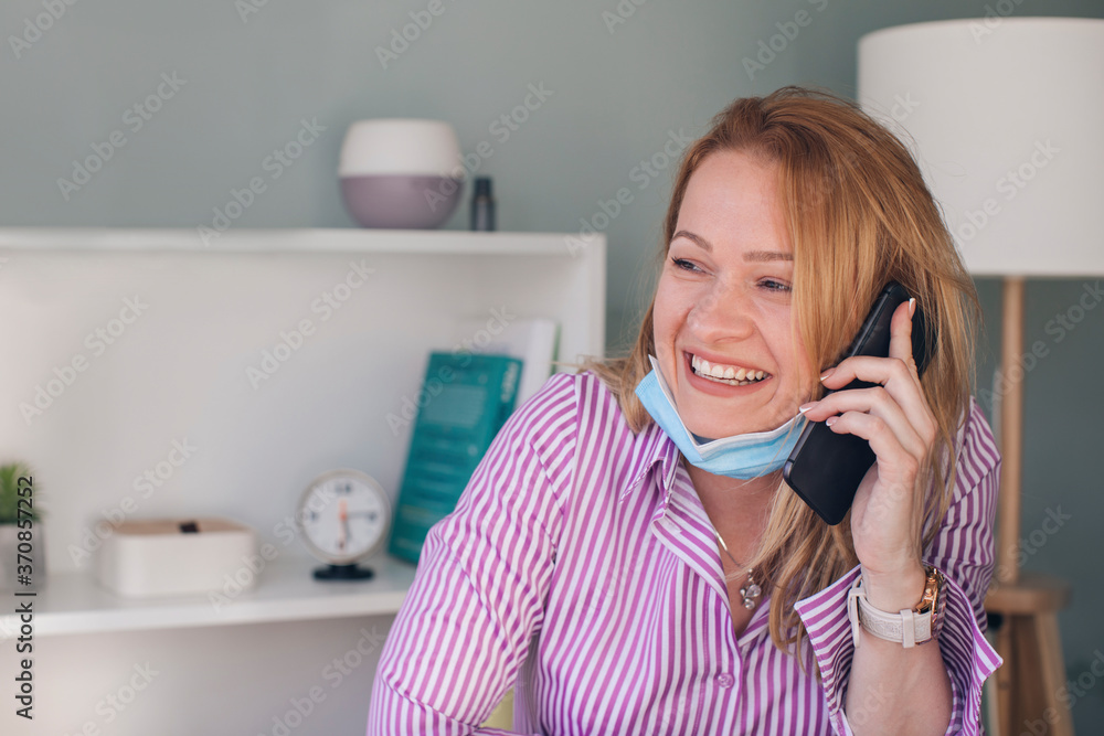 Close-up of smiling businesswoman talking over smart phone in office Close-up of smiling businesswoman talking over smart phone in office