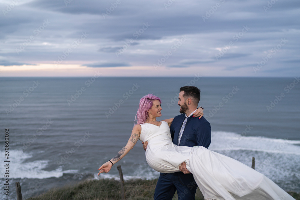 Bridal couple on viewpoint and ocean in the background Bridal couple on viewpoint and ocean in the background