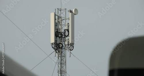Close-up shot of Telecommunication tower. Telecom tower antennas and satellite transmits the signals of cellular 5g 4g mobile signals to the consumers and smartphones. 4k. 23.98 fps