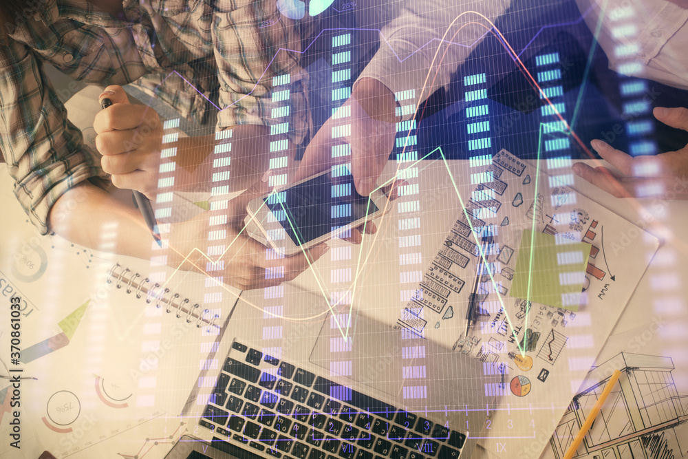 Double exposure of forex graph drawing and man and woman working together holding and using a mobile device. Trade concept. Double exposure of forex graph drawing and man and woman working together holding and using a mobile device. Trade concept.