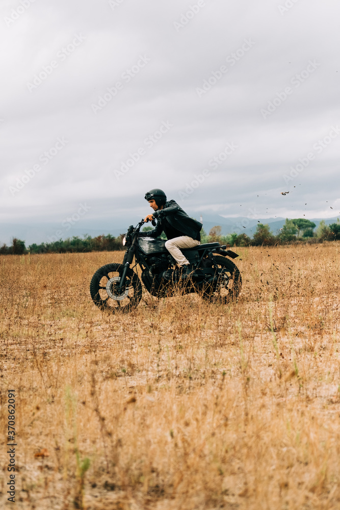 Men riding a motorbike in Italy countryside