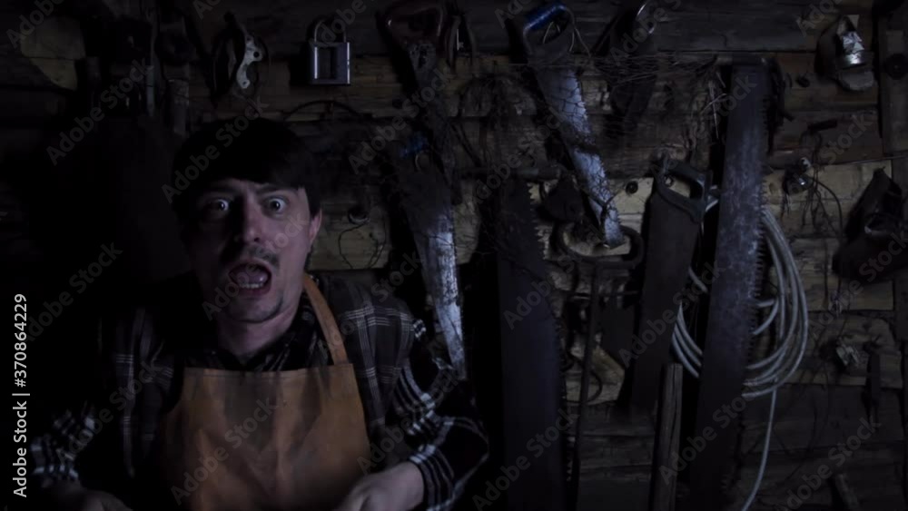 Angry crazy maniac with rusty sicator in an old house. copy space Angry crazy maniac with rusty sicator in an old house. copy space
