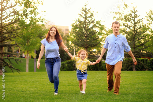 Happy family walk in the park in summer