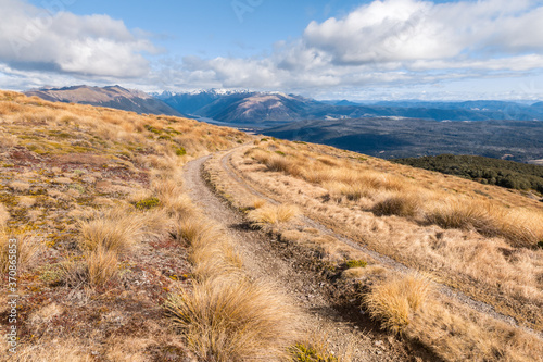 hiking track across grassy hills in Nelson Lakes National Park, South Island, New Zealand