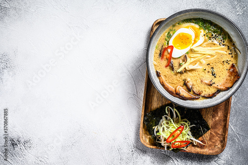 Ramen asian noodle soup with Beef tongue meat, mushroom and Ajitama pickled egg. White background. Top view. Copy space