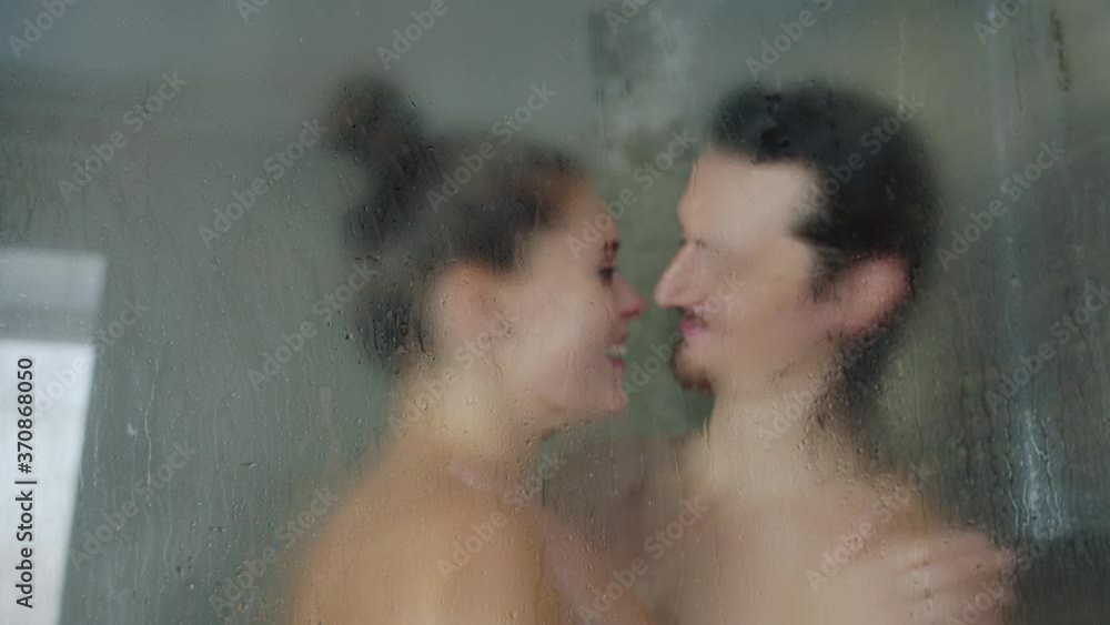 Slow motion of adorable young couple man and woman taking shower and kissing together at home, people are expressing love. Relationship and house concept. Slow motion of adorable young couple man and woman taking shower and kissing together at home, people are expressing love. Relationship and house concept.