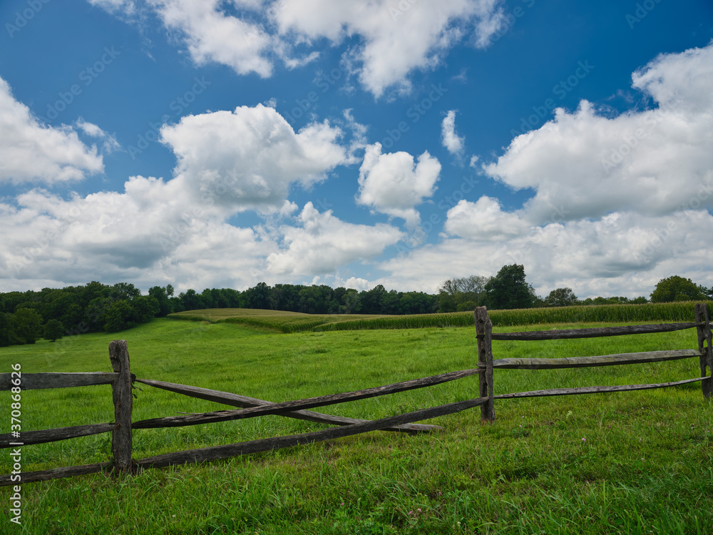 Pennsylvania Dutch country farm and cornfield surrounded by a wooden fence