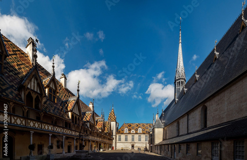 Beautiful ancient architecture of Burgundy. Streets of the city of Beaune. Sunny spring day. Advertising tourist types.