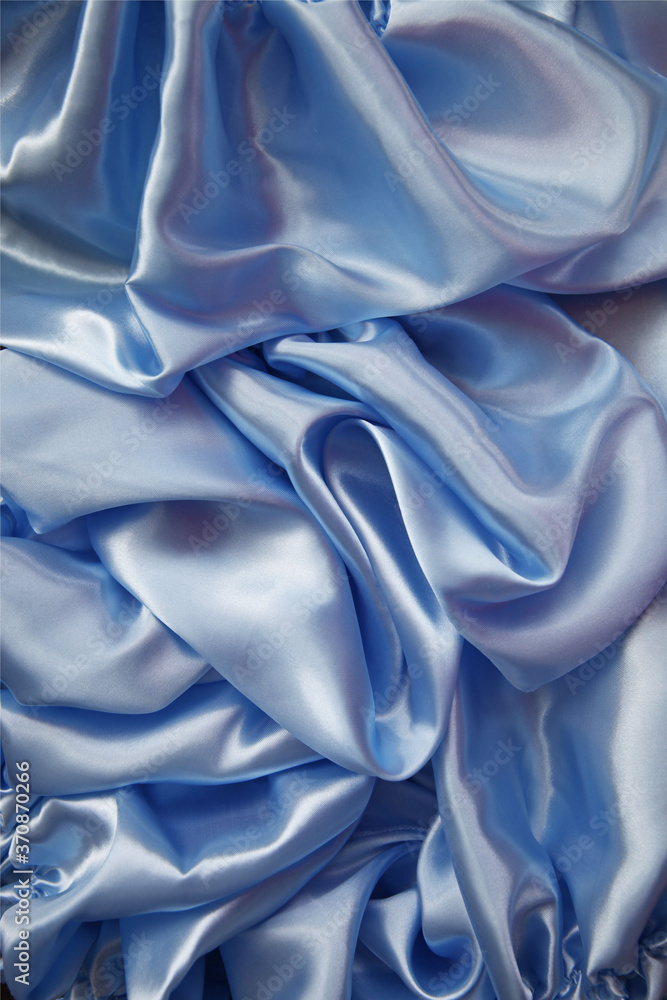 Fototapeta premium folds of silk airy light blue color, top view