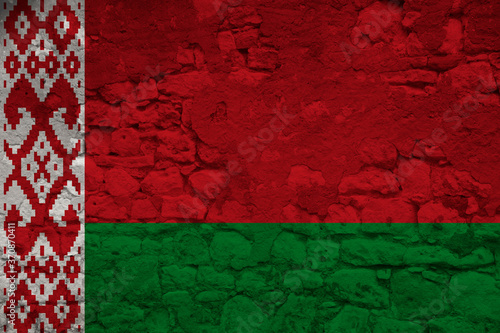 national flag of the state of Belarus on an old stone wall with cracks, the concept of tourism, emigration, economy, politics, global world trade
