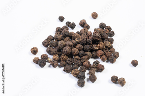 Whole black pepper, isolated on white.
