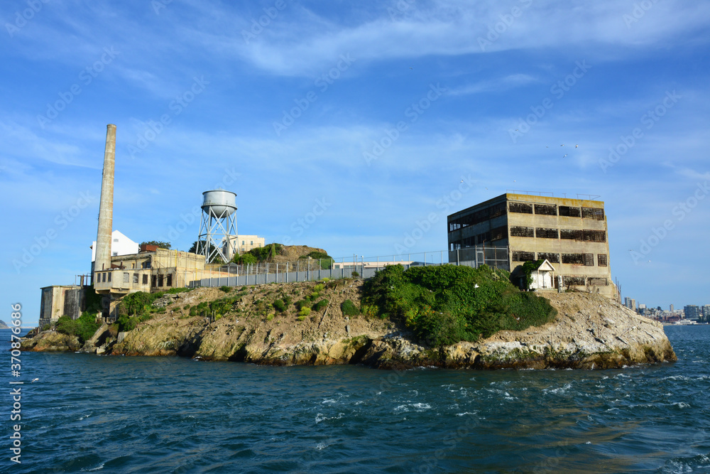 Alcatraz Island located in the middle of blue sea and blue sky under sunny day in San Francisco
