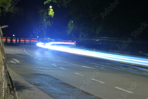 Long exposure shot of a car on the road at night