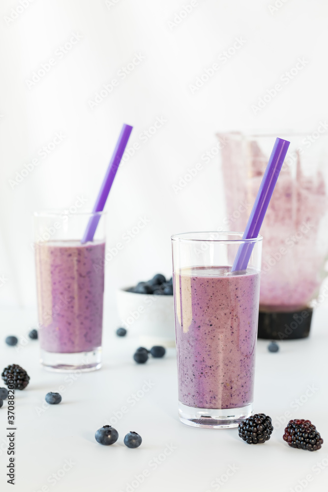 Glasses of freshly blended berry smoothie ready for drinking. Glasses of freshly blended berry smoothie ready for drinking.