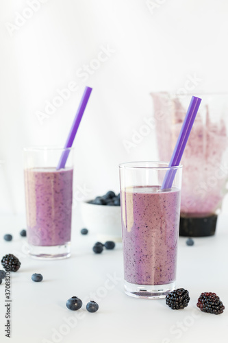 Glasses of freshly blended berry smoothie ready for drinking.