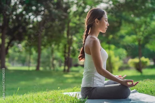 Fototapeta na wymiar Healthy women doing yoga in the moring at the park . concept healthy and outdoor activity.