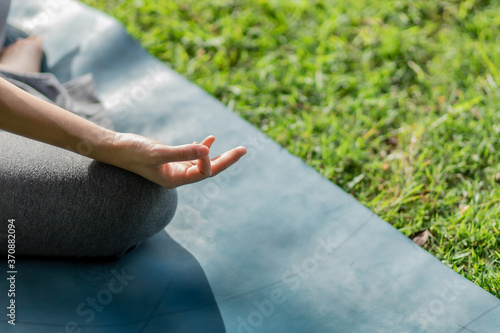 Healthy women doing yoga in the moring at the park . concept healthy and outdoor activity.