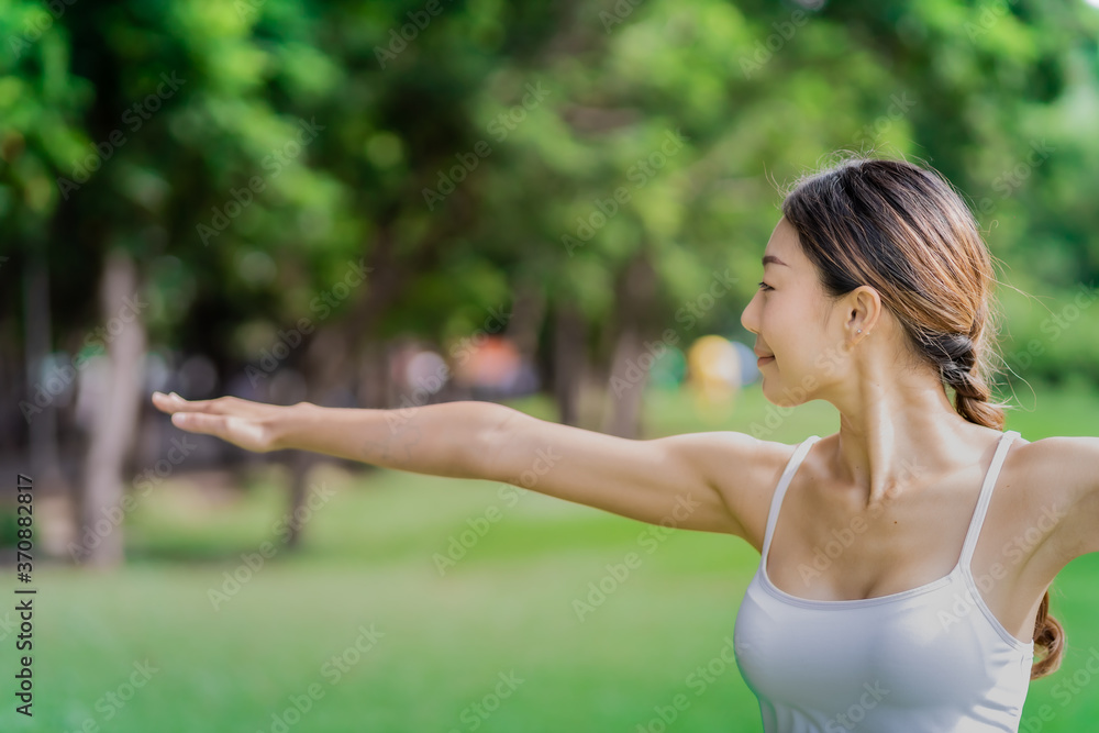 Healthy women doing yoga in the moring at the park . concept healthy and outdoor activity. Warrior2 pose Healthy women doing yoga in the moring at the park . concept healthy and outdoor activity. Warrior2 pose