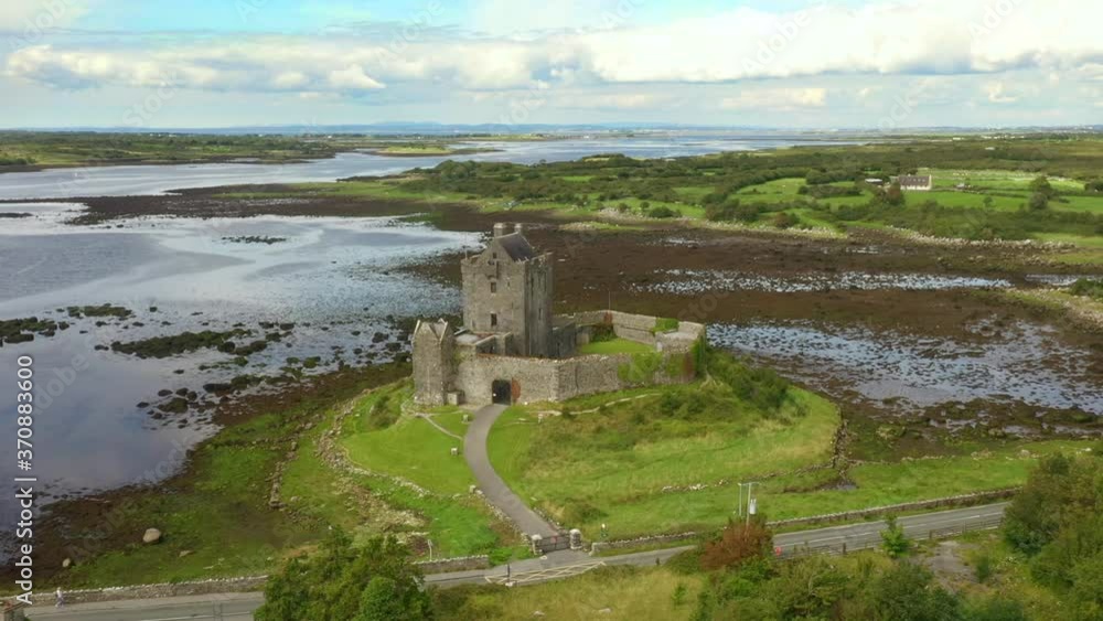 Dunguaire Castle, Kinvara, Galway, Ireland, August 2020, Drone slowly orbits castle passing vista of Galway Bay revealing Kinvara Village in background. Dunguaire Castle, Kinvara, Galway, Ireland, August 2020, Drone slowly orbits castle passing vista of Galway Bay revealing Kinvara Village in background.