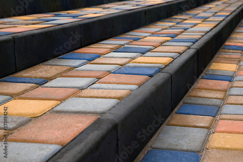 Stairs covered colorful paving slabs. Perspective view photo