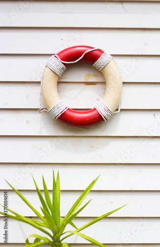 Decorative life preserver on rustic weather board wall
