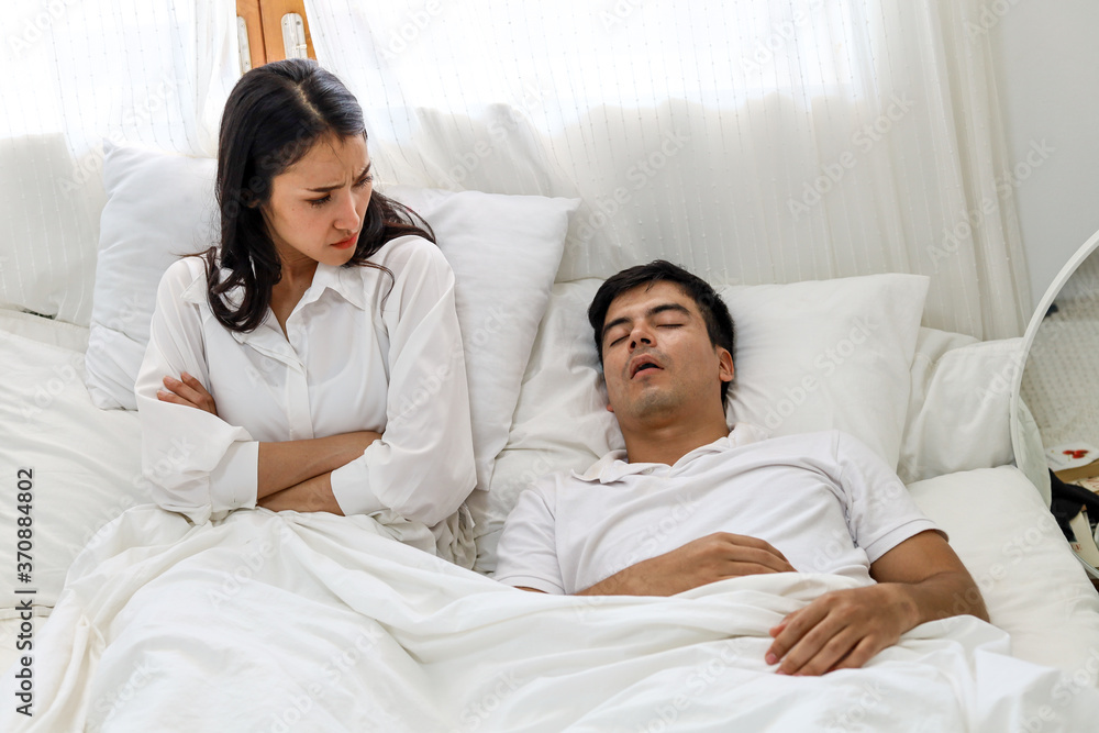Wife can't sleep Because the husband snores loudly on bedroom in morning. Wife can't sleep Because the husband snores loudly on bedroom in morning.