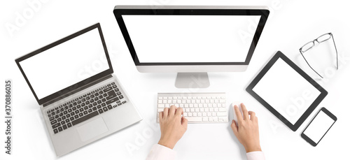 Hand on desktop keyboard with blank screen monitor