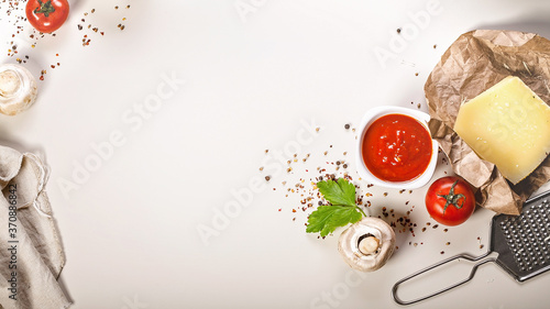 Food banner. Flat lay ingredients for making pizza or pasta. Classic Mediterranean recipes. Tomato sauce, mushrooms, spices, Parmesan cheese and fresh herbs. Copy space