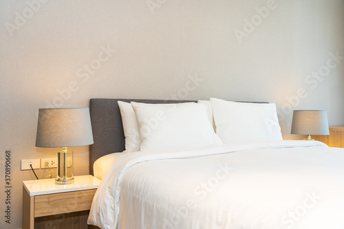 White pillow on bed decoration interior of bedroom interior with light lamp
