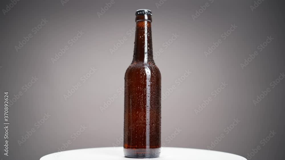 Rotation of beer bottle covered with drops Rotation of beer bottle covered with drops