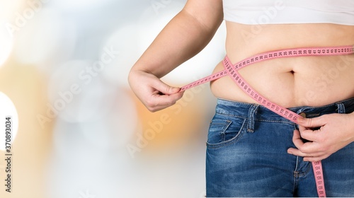 Obesity overweight woman with measuring tape