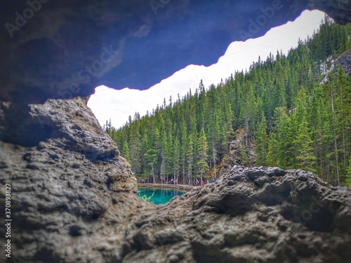scenery from cave looking onto lake and forest 
