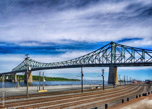 train trains in front of steel suspension bridge