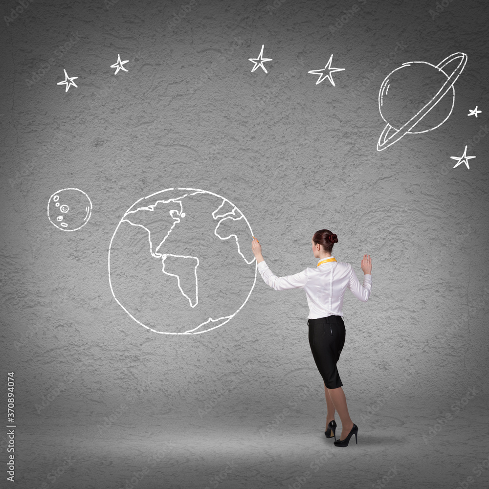 Rear view of businesswoman presenting drawn planet Rear view of businesswoman presenting drawn planet