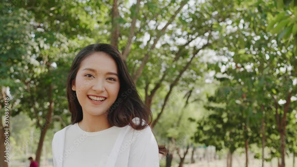 Authentic close up Happy smiling pretty asian woman. Enjoy nature in park for summer. Beauty black hair. End of quarantine and return to Travel around the world Authentic close up Happy smiling pretty asian woman. Enjoy nature in park for summer. Beauty black hair. End of quarantine and return to Travel around the world