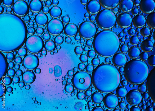 Abstract colorful bubbles. Mixing water and oil. Unrealistic colored blue bubbles. Can be used as a festive background