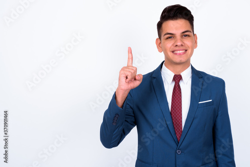 Portrait of happy young handsome multi ethnic businessman in suit