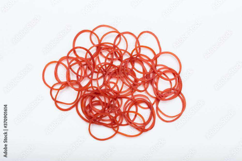 Red rubber bands on white background. Isolated rubber band. Pile of rubber bands. Red rubber bands on white background. Isolated rubber band. Pile of rubber bands.