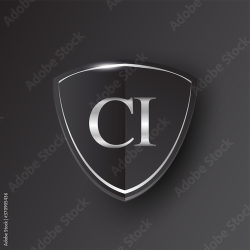 Initial logo letter CI with shield Icon silver color isolated on black background, logotype design for company identity.