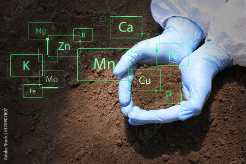 Scientist with sample of so...