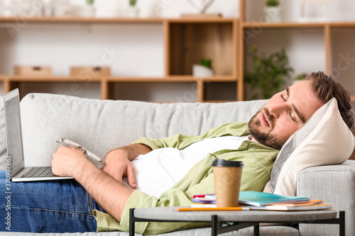 Tired male student sleeping...